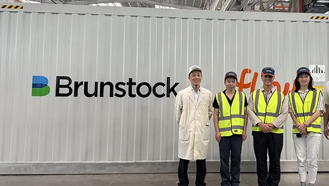 Daniel Tragai, CEO of Kookaburra Power Technologies, standing in front of one of the Coonawarra BESS energy storage containers at the Brunstock factory.